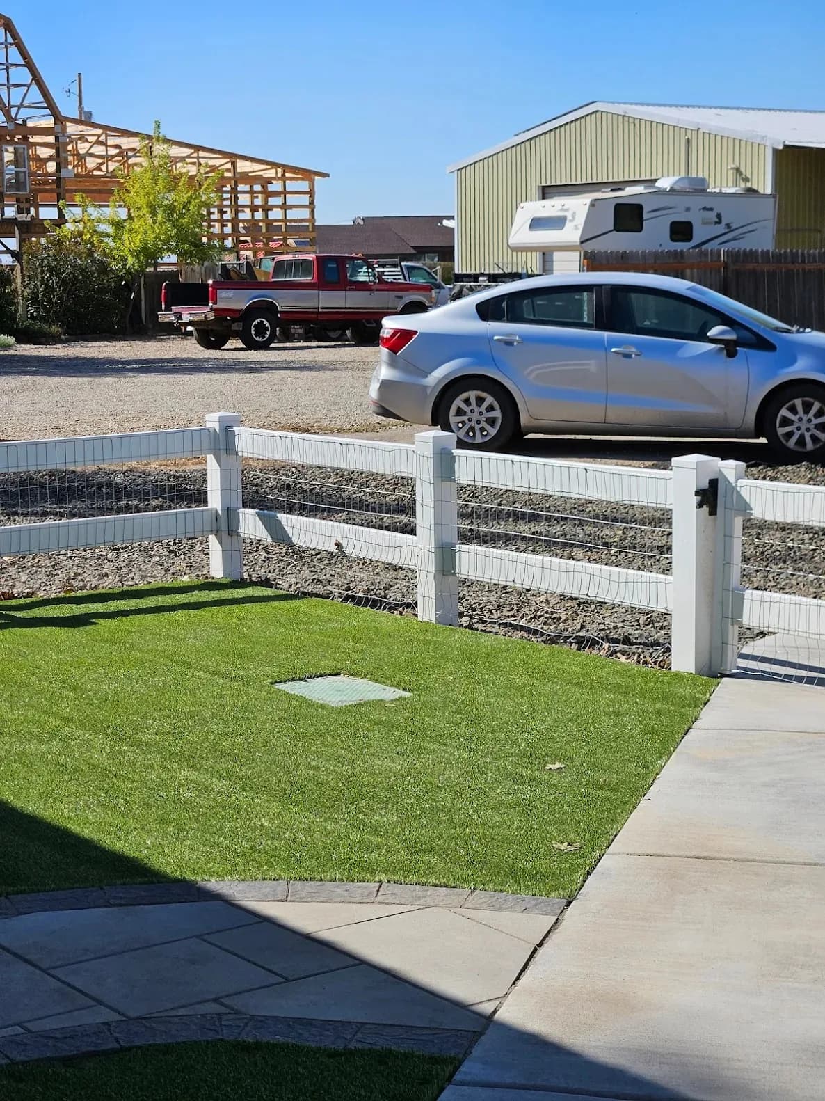 artificial turf lawn paver patio concrete walkway white vinyl fence