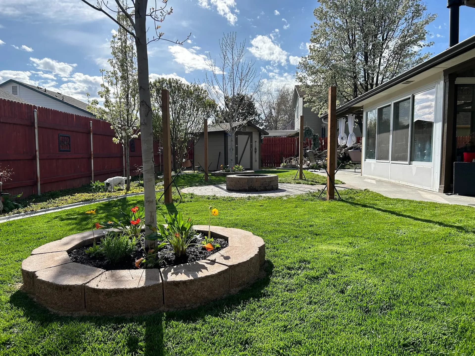 backyard landscape design paver fire pit patio raised planters and lawn