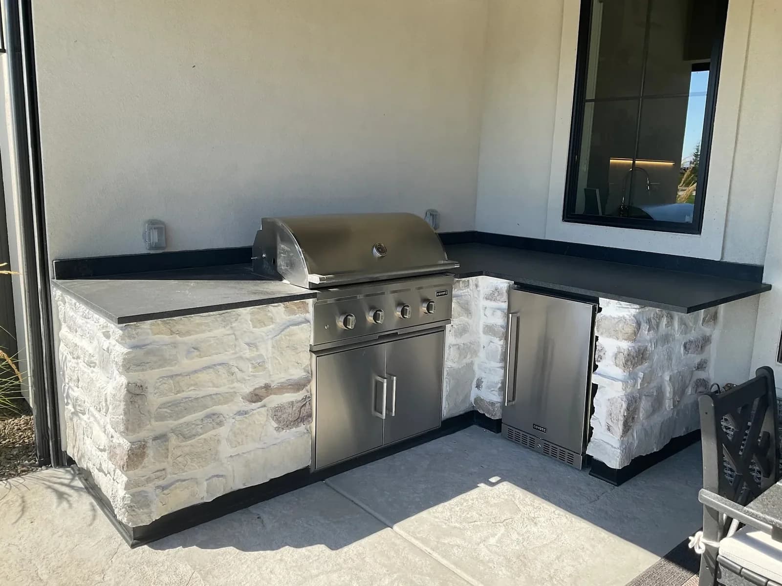 custom outdoor kitchen coyote grill stone veneer concrete patio