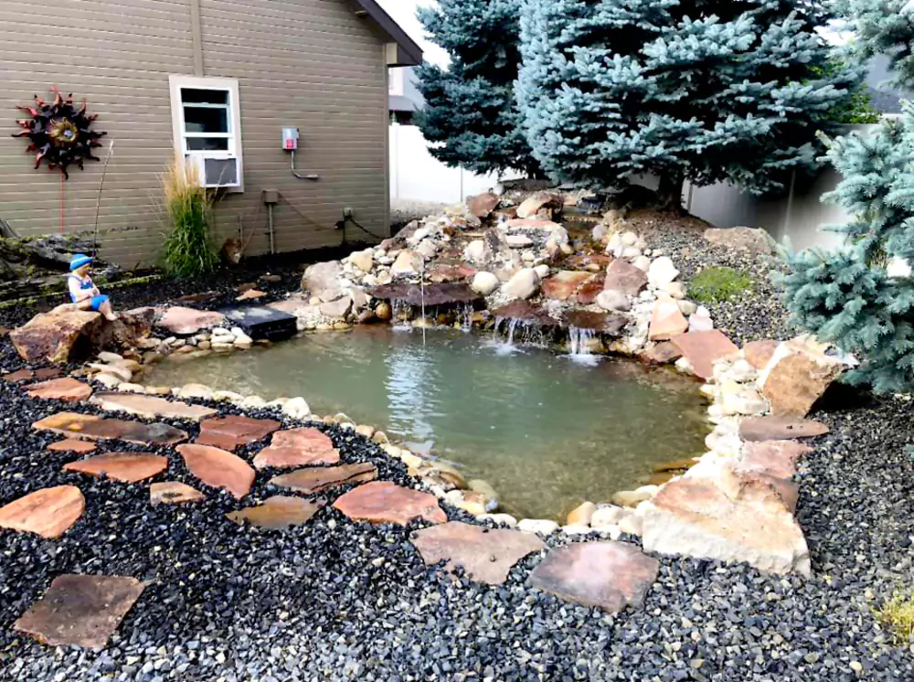 208-specialties-landscaping-hardscaping-project-boise-idaho-custom-water-feature-and-pond-with-flagstone-surround-photo-1-68599ddb277e2