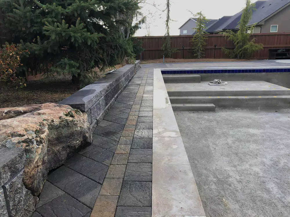 208-specialties-landscaping-hardscaping-project-eagle-idaho-custom-pool-landscaping-with-stone-edging-and-retaining-wall-photo-1-68599db7c834f
