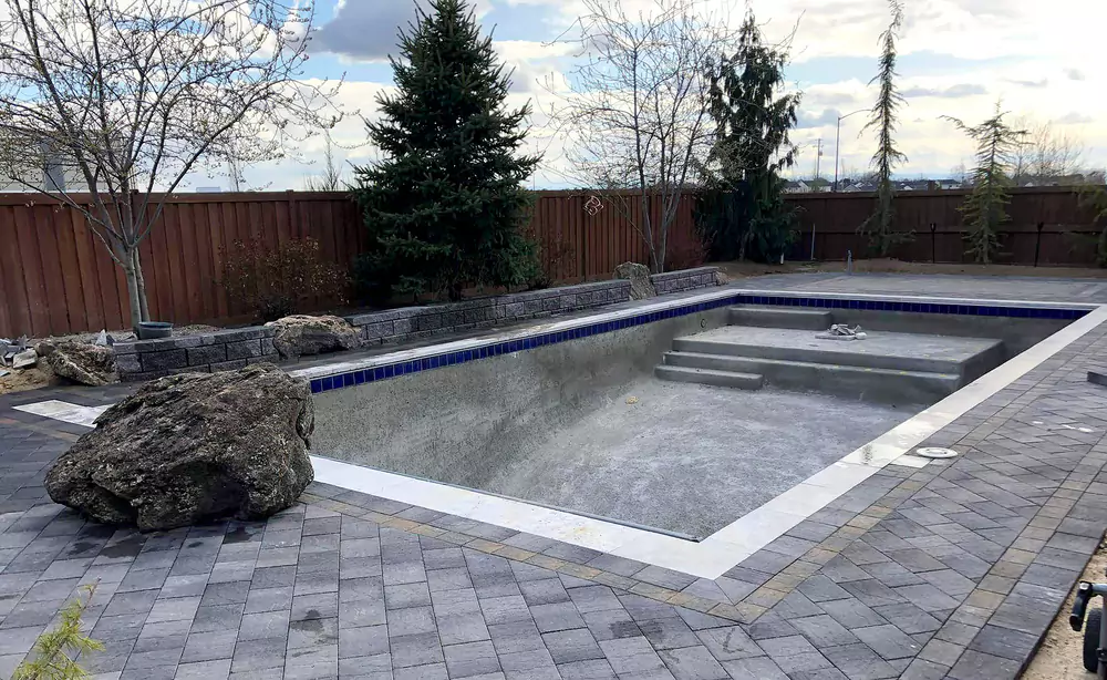 208-specialties-landscaping-hardscaping-project-eagle-idaho-custom-pool-landscaping-with-stone-edging-and-retaining-wall-pool-photo-3-68599db8f262a
